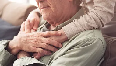 Carer supporting elderly resident with dementia