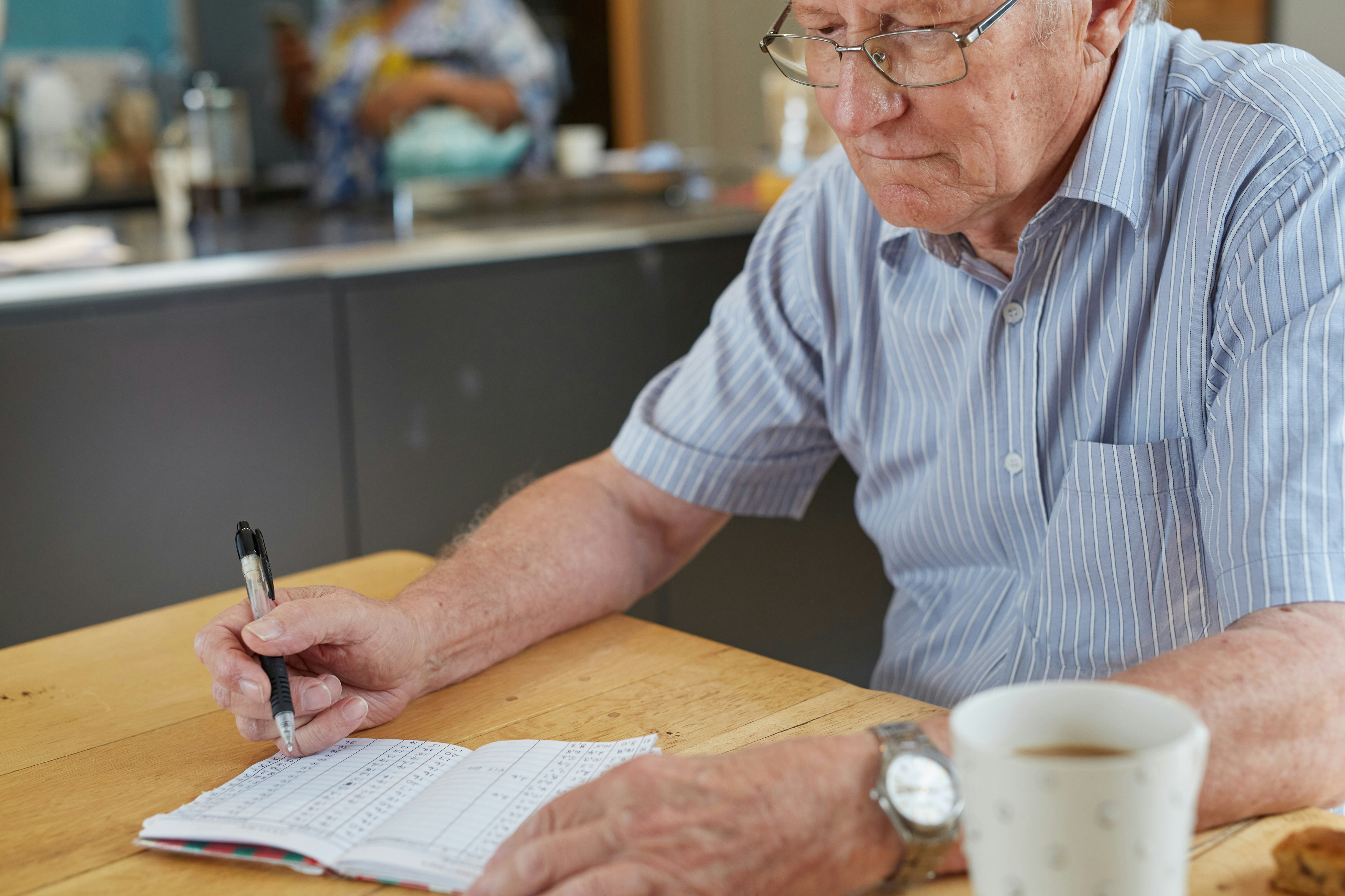 Person reviewing financial documents for care home planning